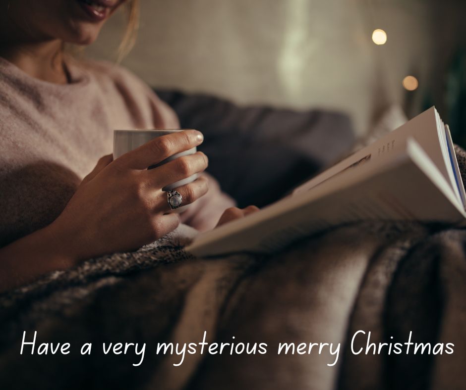 A woman reading a book in a softly room lit with a mug in her hand.
